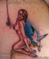 Mini pinup girl tattoo with a fishing theme